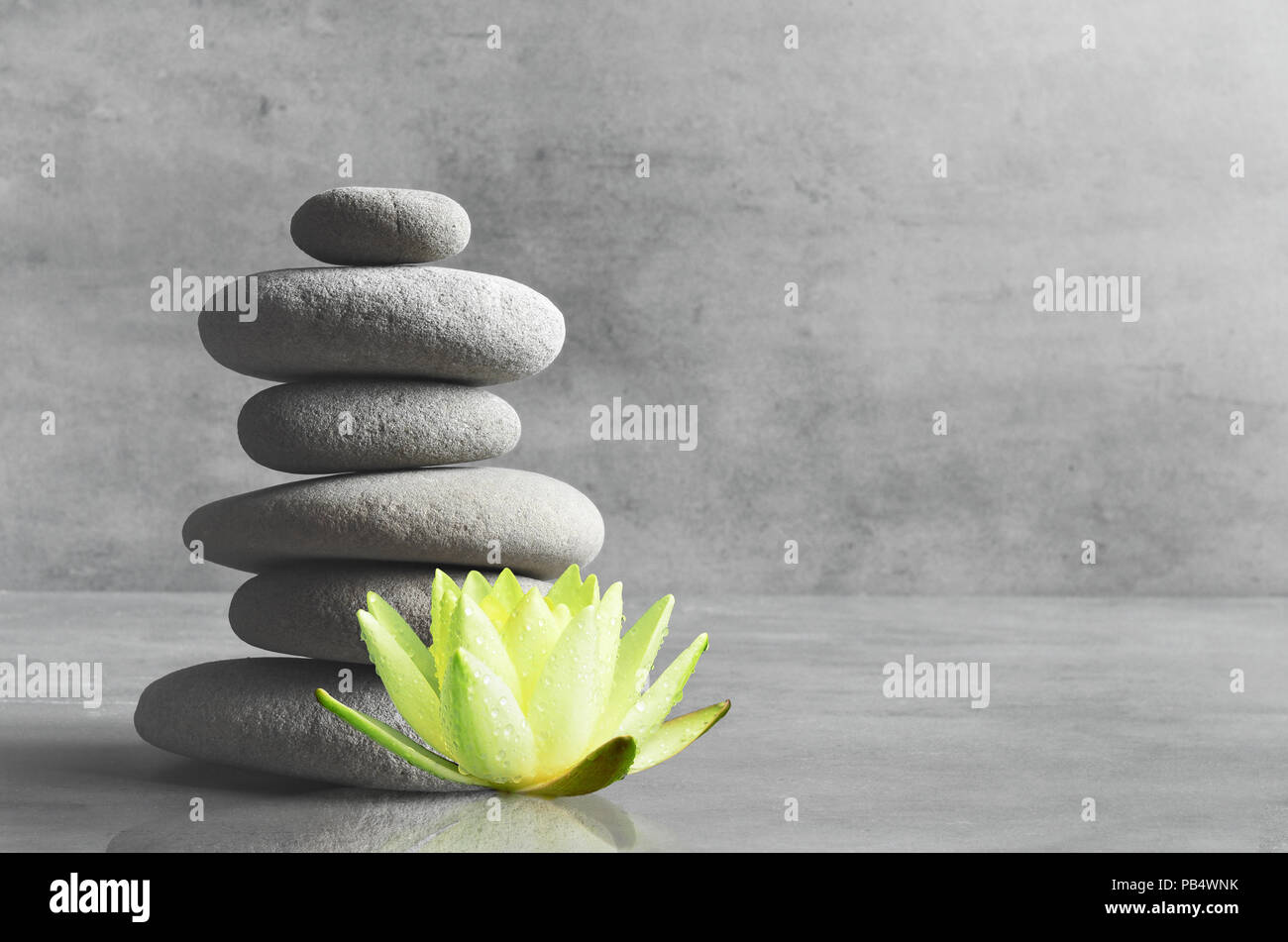 Equilibrio di pietre e fiore bianco lotus. Zen e concetto di spa. Foto Stock