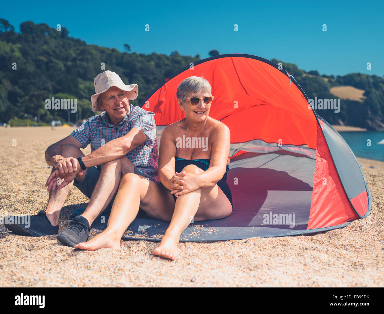 Una coppia senior è rilassante in un rifugio sulla spiaggia Foto Stock