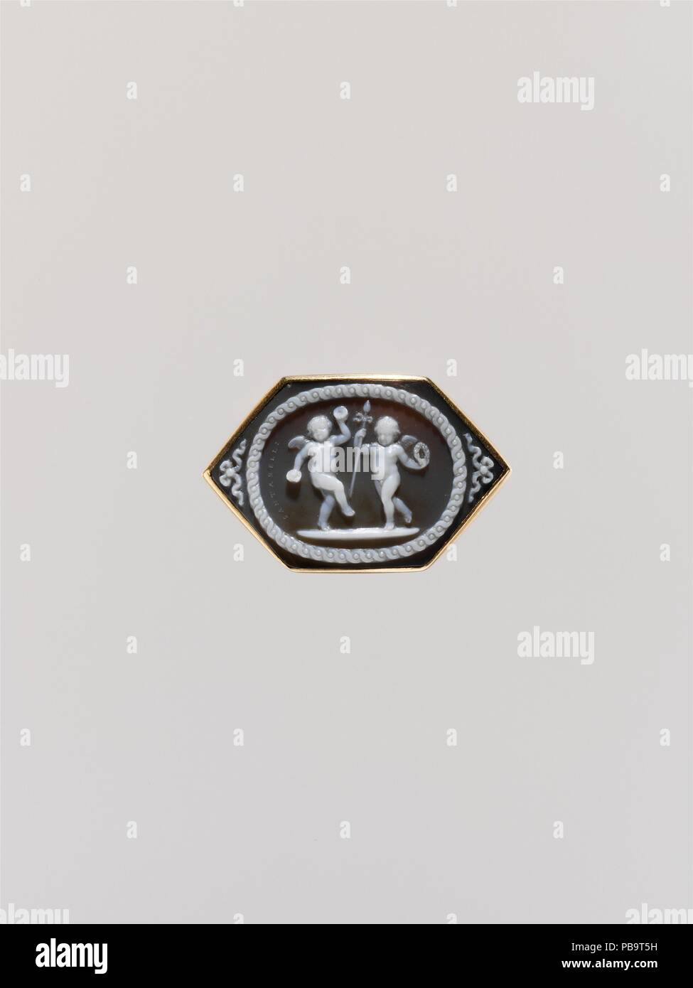 Dancing amorini con simboli Bacchic. Artista: Giovanni Antonio Santarelli (Italiano, 1758-1826 Manopello Firenze). La cultura italiana, Firenze. Dimensioni: complessivo: 11/16 x 1 1/8a. (1,7 x 2.9cm); visibile cameo (conferma): 17,5 x 26,8 mm. Data: tardo XVIII-XIX secolo. La dolce terra grigio è un foglio per movimento delicato ed ornamento. Giovanni Santarelli della cera originale sul modello di ardesia (Museo Nazionale del Bargello di Firenze è di forma ovale. Egli ha ampliato il campo di composizione su un più ampio esagono, sin dall'inizio rilevare la sua idoneità per un anello. Museo: Metropolitan Museum of Art di New York, U Foto Stock