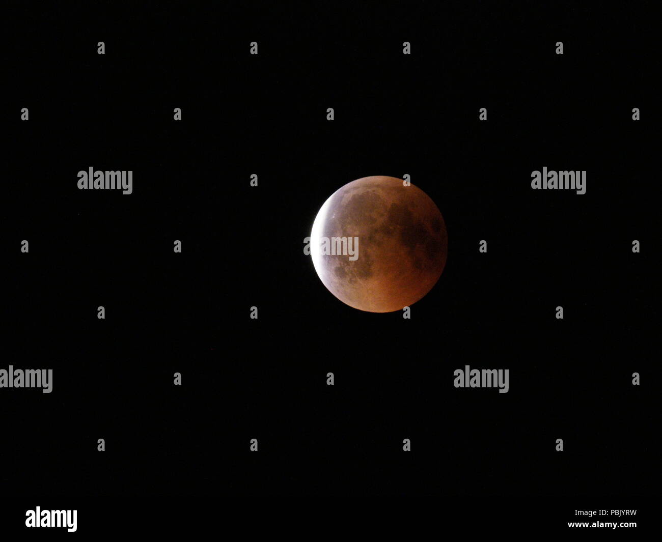 Vista della luna di sangue durante la più lunga Eclissi lunare totale del XXI secolo sul cielo nero visto dalla Polonia nel 2018 durante le calde serate estive il Venerdì, 27 luglio. Foto Stock