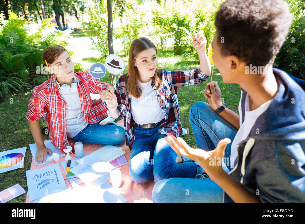 Giovane biondo e sensazione dello studente arrabbiato utilizzando il bianco pensando hat Foto Stock