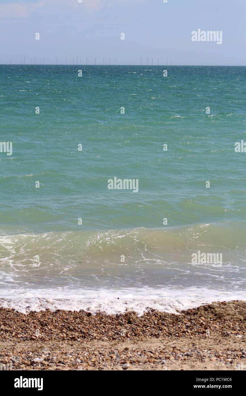 Marea sulla spiaggia di ciottoli in Goring-da-mare Foto Stock