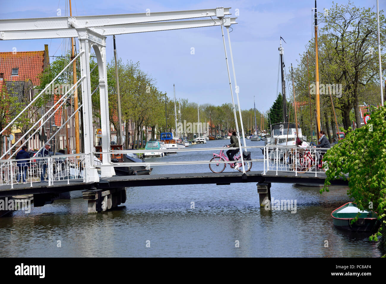 Ciclista sulla verticale del ponte di sollevamento nel grazioso olandese di piccole città di Edam ben noto per la sua produzione di formaggio Foto Stock