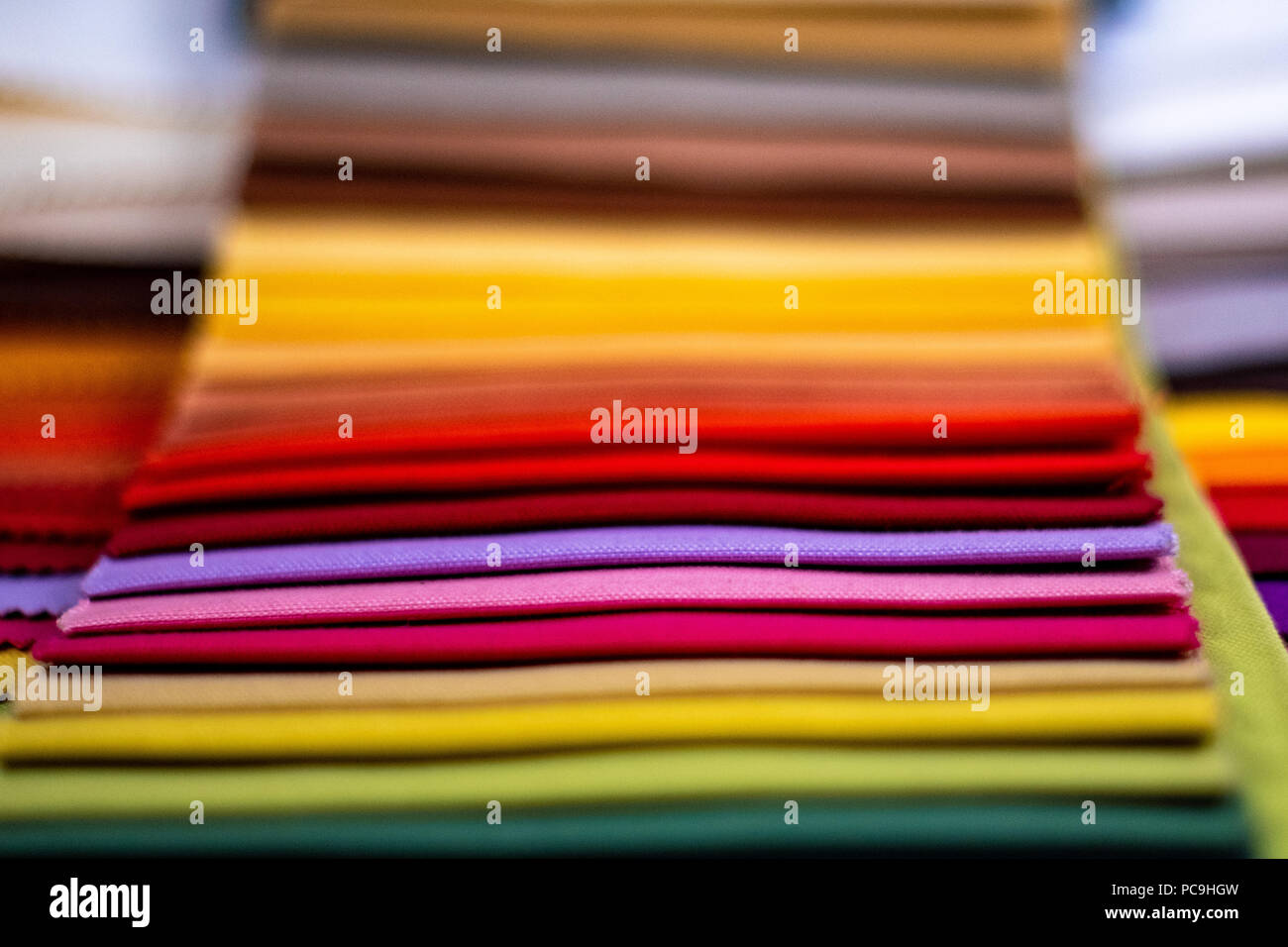 Display a colori dei tessuti per l'industria della moda, tutti i colori disponibili di diversi tipi di tessuto. Paletta di colori Foto Stock
