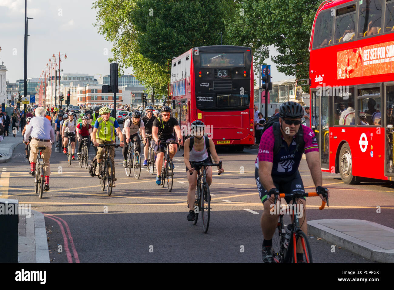 I ciclisti il pendolarismo su CS6 superhighway ciclo su Blackfriars Road in ora di punta con autobus rossi e traffico in Road, London, Regno Unito Foto Stock