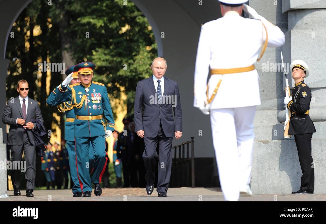 Il presidente russo Vladimir Putin, centro è salutato da Nakhimov Scuola Navale di testa Minakov Anatoly, destra e e il ministro della Difesa Sergei Shoigu come egli arriva per una visita alla Nakhimov Scuola Navale della Marina Militare durante le celebrazioni della festa il 29 luglio 2018 a San Pietroburgo, Russia. Foto Stock