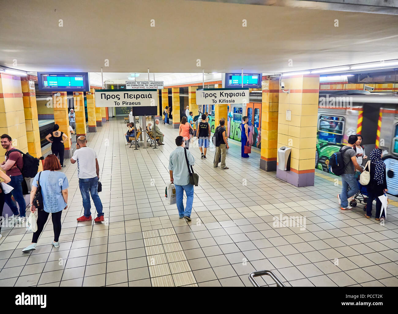 Le persone in attesa di un treno in una La stazione della metropolitana di Atene. Foto Stock