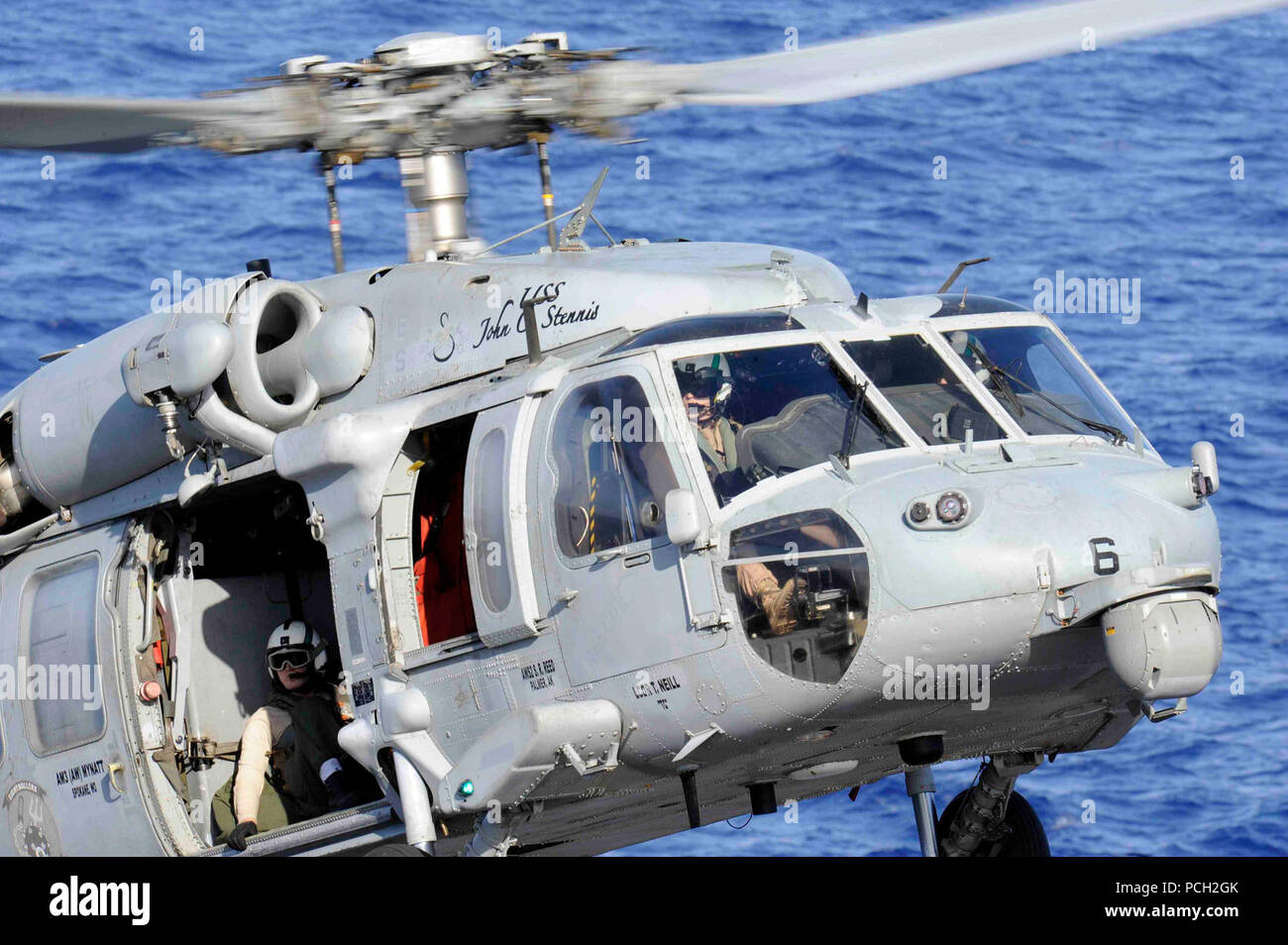 Oceano Pacifico (Aprile 14,2013) un MH-60S Sea Hawk elicottero dall'Eightballers di elicottero di mare squadrone di combattimento (HSC) 8 scende dal cargo militare comando Sealift flotta oliatore di rifornimento USNS Yukon (T-AO-202) per la portaerei USS John C. Stennis (CVN 74) durante un rifornimento in mare. John C. Stennis è distribuito negli Stati Uniti 7 flotta area di responsabilità condurre le operazioni di sicurezza marittima e di protezione del teatro gli sforzi di cooperazione. Foto Stock