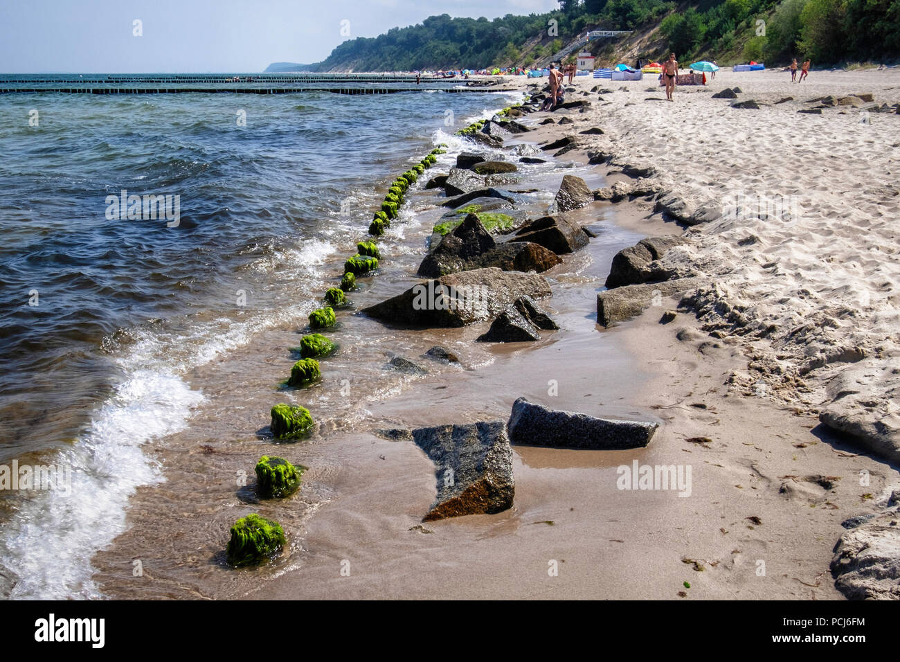 Germania Loddin,Stubbenfelde spiaggia.di balneazione costiere resort sull'isola di Usedom sul Mar Baltico. Rocks & legno groyne prevenire erosione della spiaggia sabbiosa Foto Stock