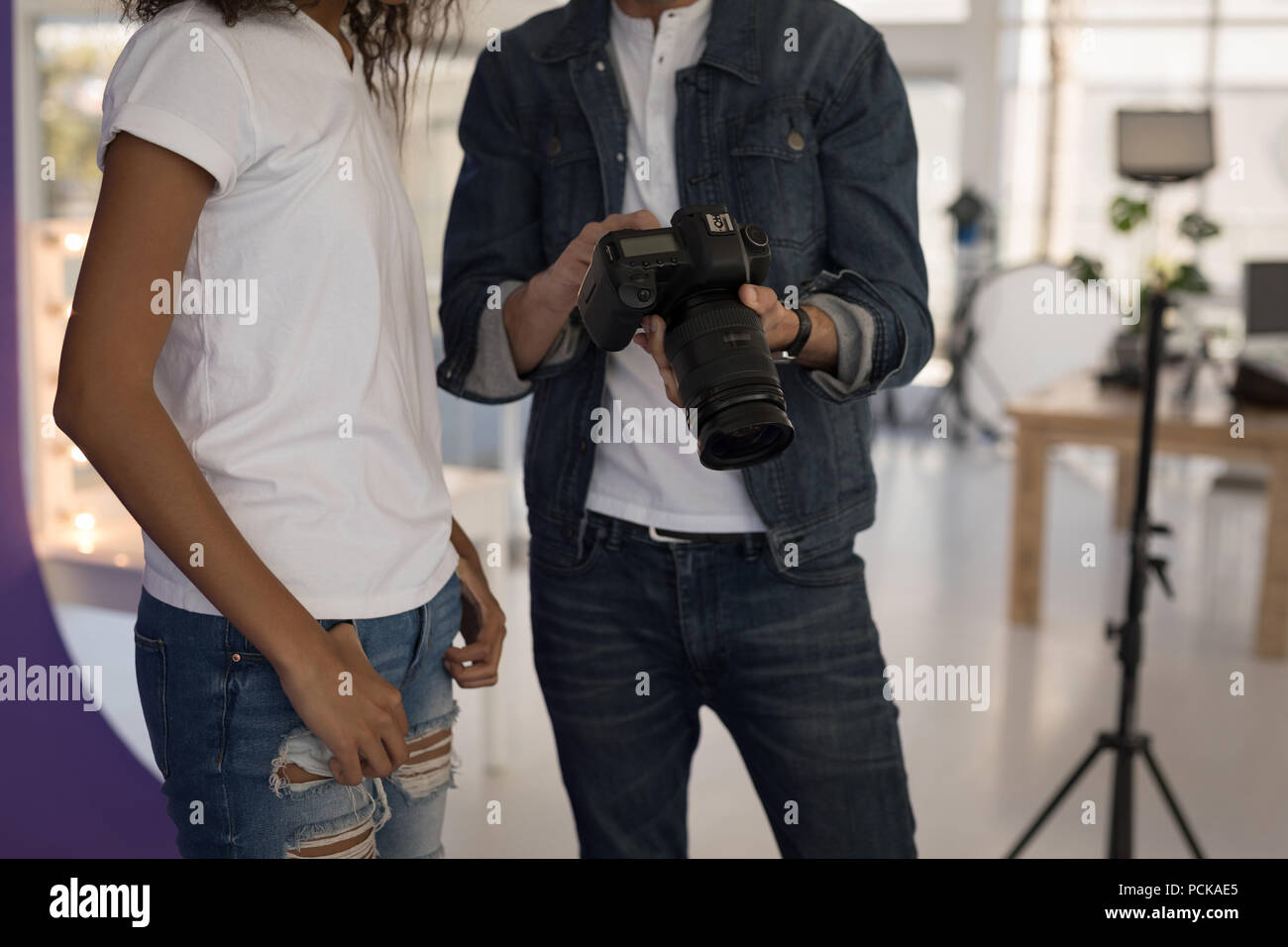 Il fotografo che mostra le foto di moda su un modello di fotocamera digitale Foto Stock