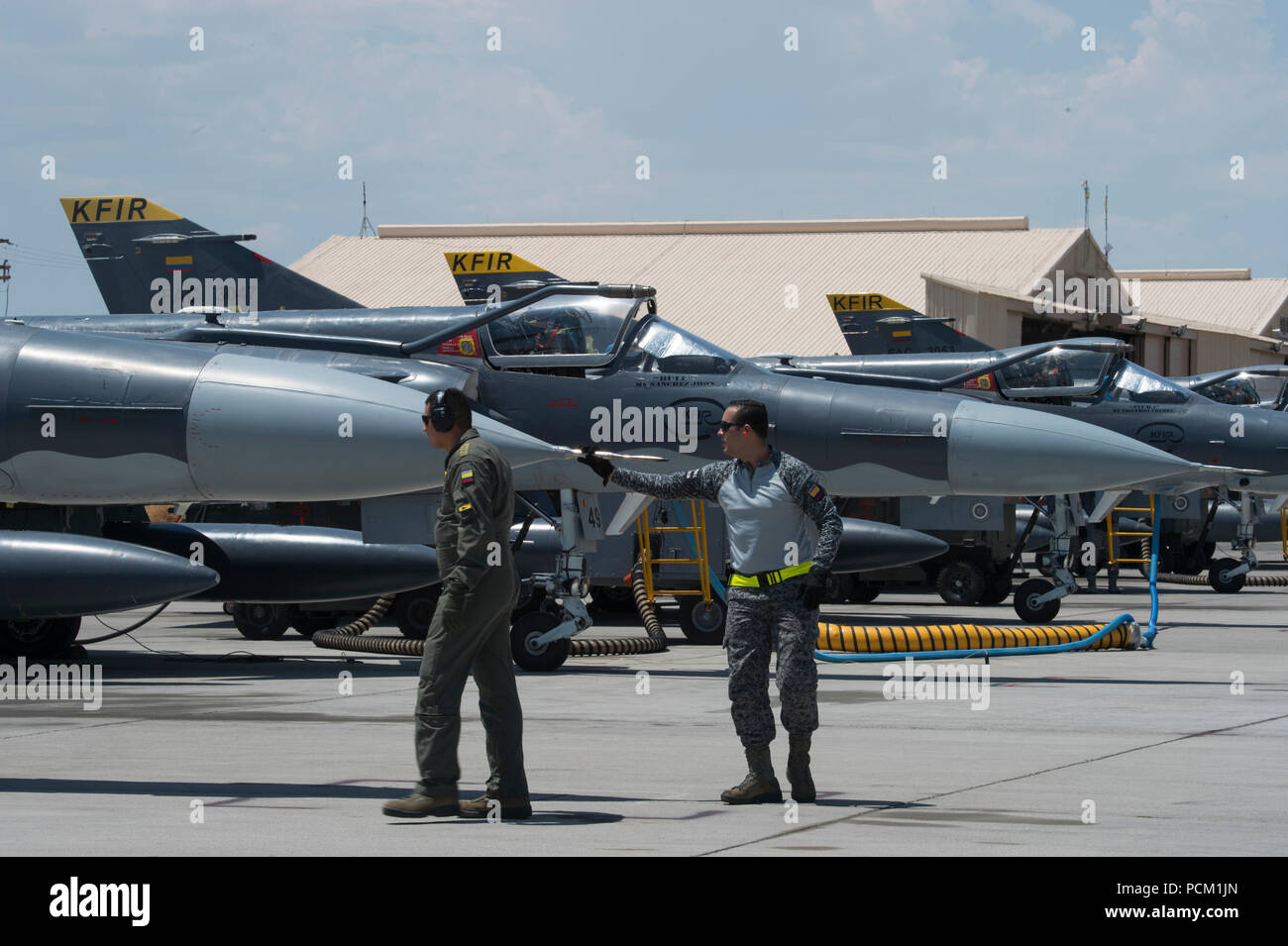 Un colombiano Air Force Kfir fighter jet pilota e capo equipaggio condotta pre-volo ispezioni sul getto durante la bandiera rossa 18-3 presso la Base Aerea Militare di Nellis Nev., 27 luglio 2018. Il Colombiano Air Force Kfir figher getti sono la formazione a fianco degli Stati Uniti Sforzi durante la bandiera rossa 18-3 in realistico air-air Combat training scenari. (U.S. Air Force photo by Staff Sgt. Angela Ruiz) Foto Stock