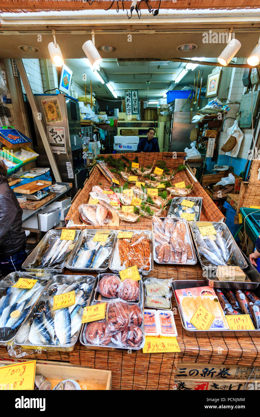 Kuromon Ichiba, mercato alimentare di Osaka. Il piccolo pesce monger shop con vari pesci disposti in contenitori di metallo rivestito in materiale plastico termoretraibile. Foto Stock