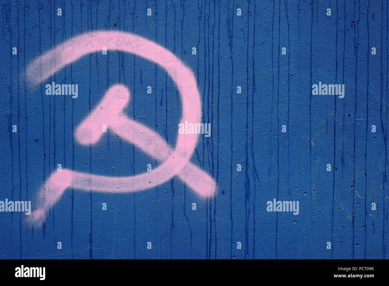 Il simbolo di falce e martello della bandiera dello stato dell'ex Unione Sovietica e il comunismo su una parete blu Foto Stock