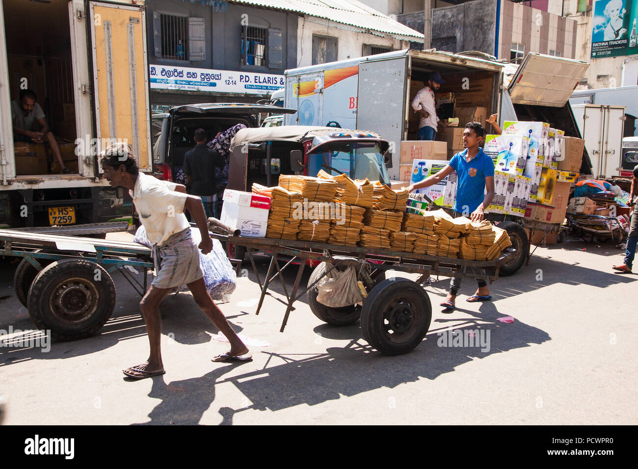 COLOMBO SRI LANKA - Dic 24, 2016: Il portiere al mercato Pettah andando contro la folla con carrello completo sul dicembre 24, 2016 in Colombo. Lo Sri Lanka. Foto Stock