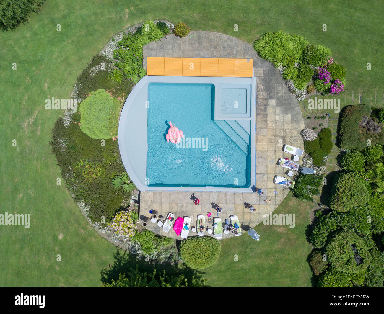 Una veduta aerea da fuco di alcuni amici avente una giornata di relax presso la piscina in un giorno di estate in Cile all'interno di una Villa bel giardino verde Foto Stock