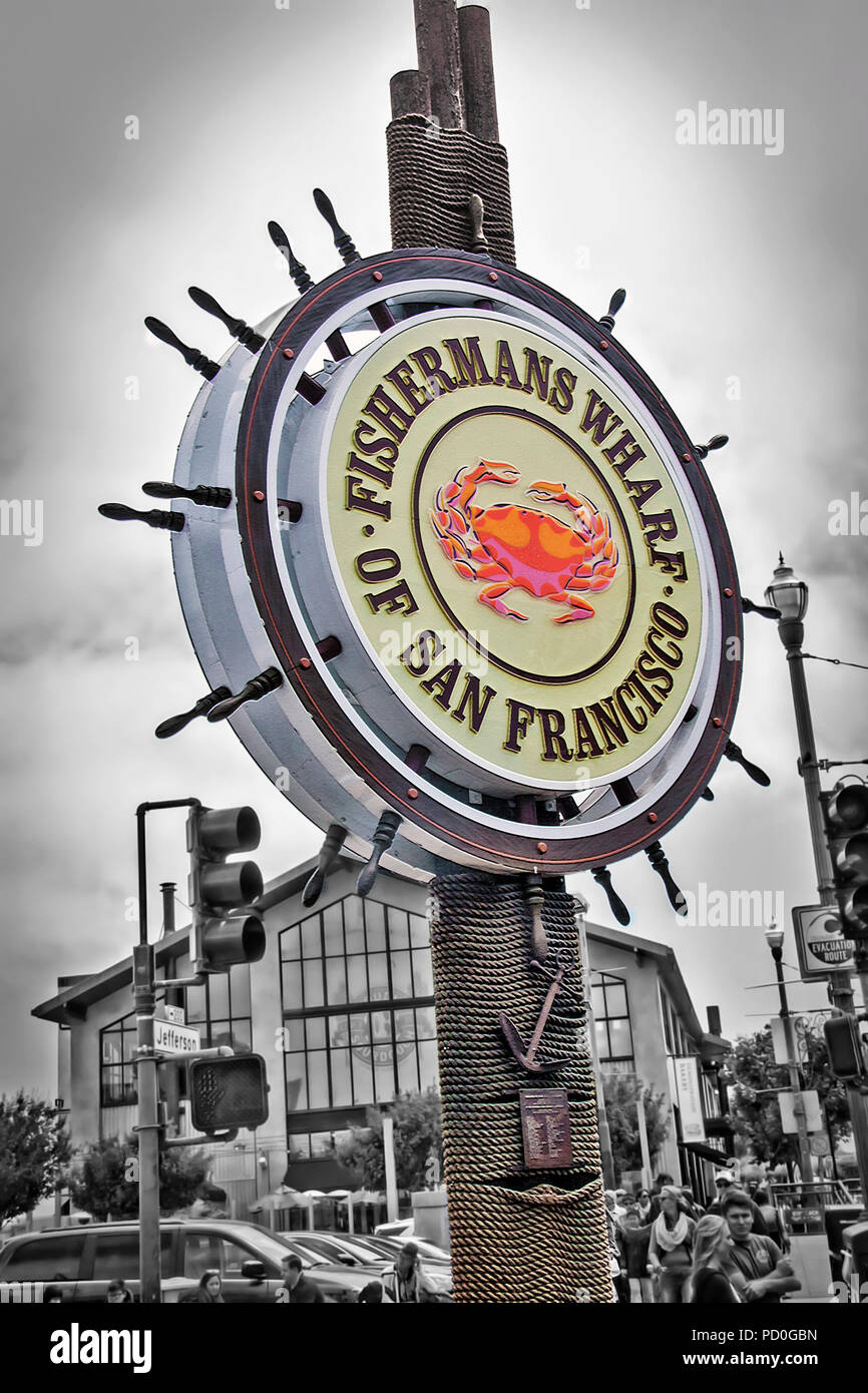 Una foto del landmark Fisherman Wharf segno a San farncisco ha, in California con i turisti sulla strada sottostante. Lo sfondo è stato dissaturato whi Foto Stock