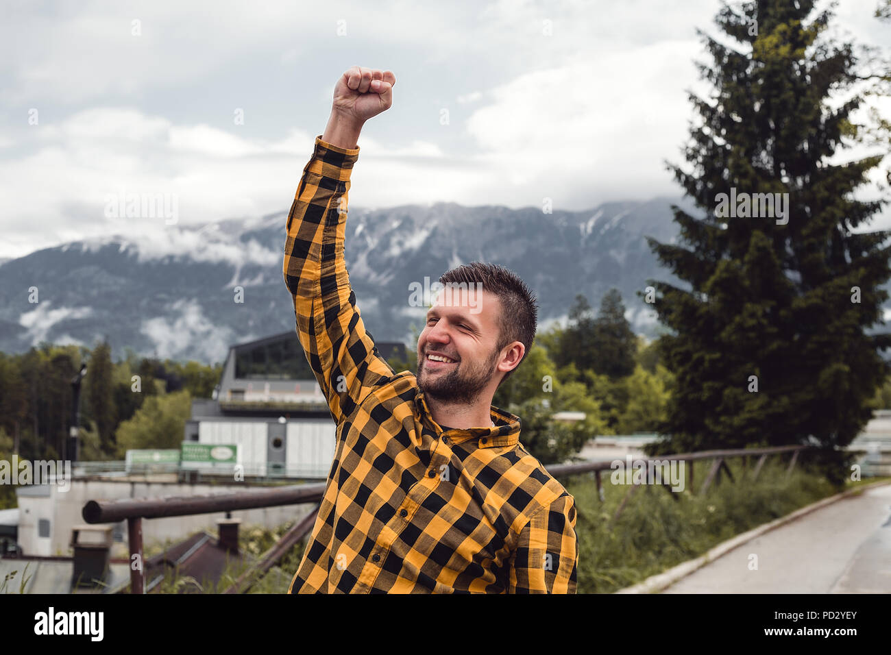 Felice l'uomo facendo un pugno nel villaggio di montagna, Dolenci, Slovenia Foto Stock