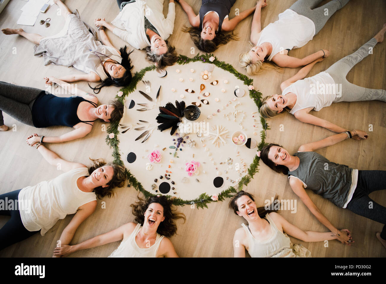 Le donne intorno al cerchio nel ritiro di yoga Foto Stock