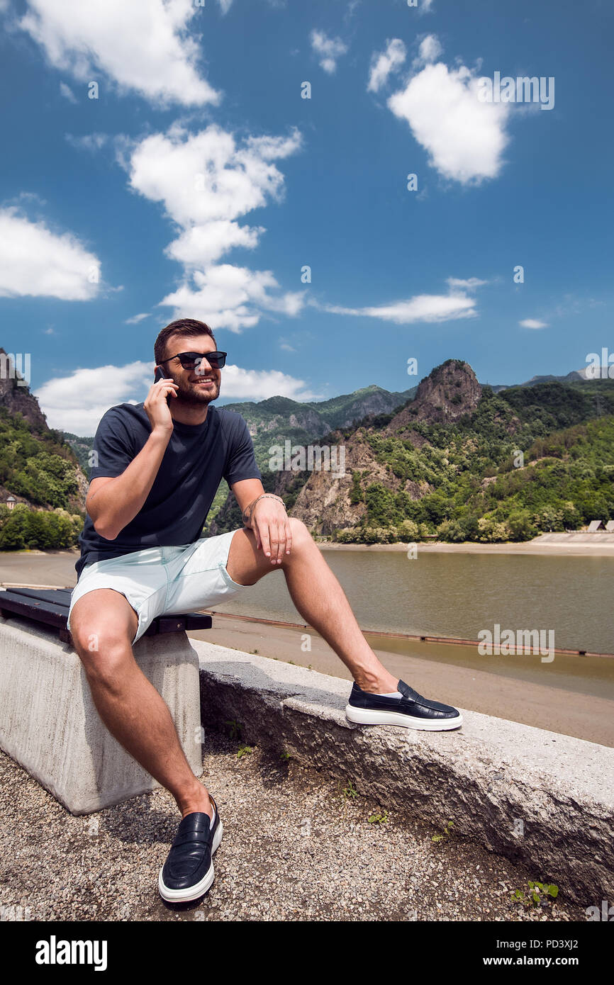 Uomo che utilizza il telefono cellulare dalla spiaggia, Draja, Vaslui, Romania Foto Stock
