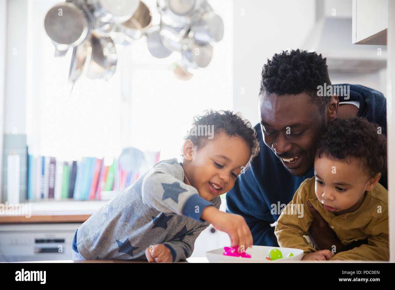 Felice padre e figli giocare con i giocattoli Foto Stock