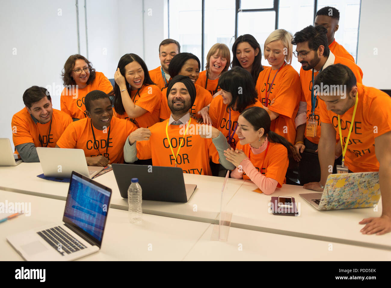 Ritratto fiduciosi gli hacker che codifica per la carità a hackathon Foto Stock