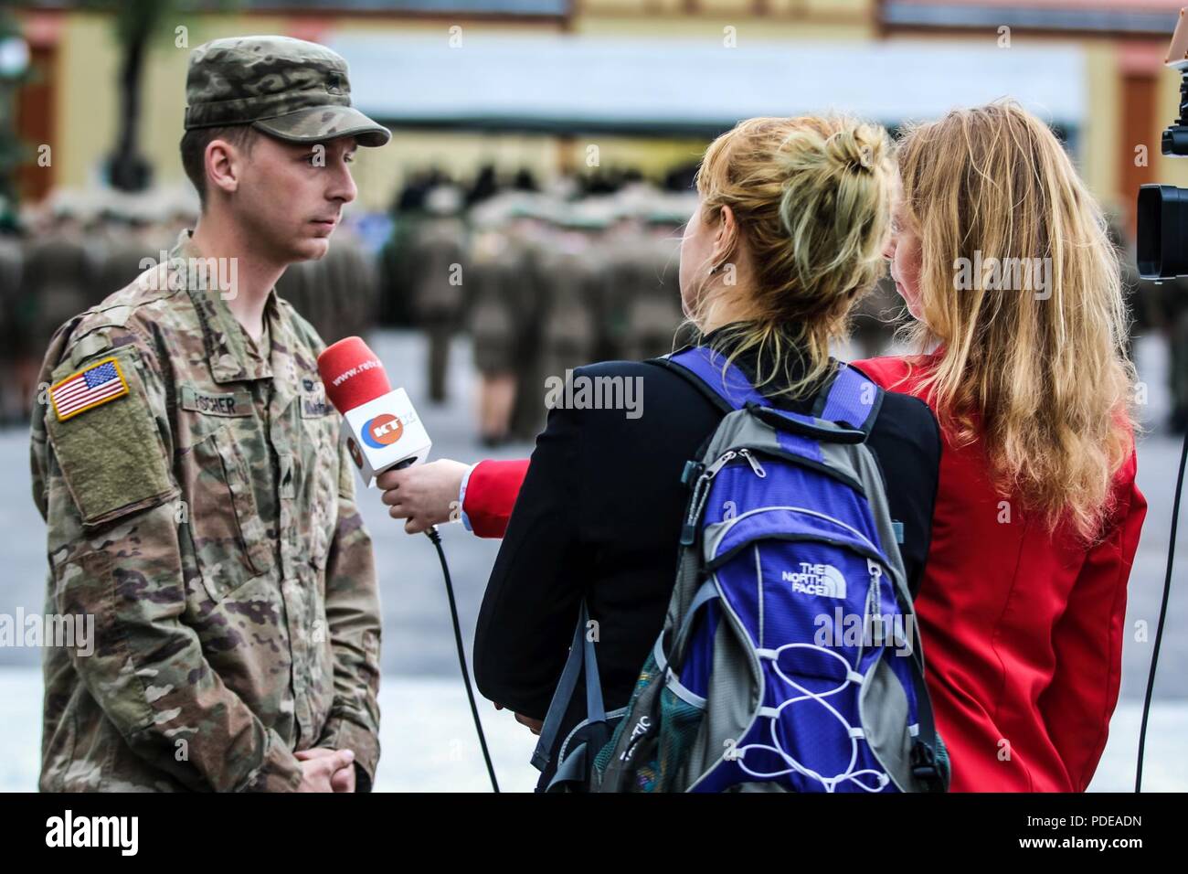 Sgt. Patrick Fischer (sinistra), a Milwaukee, Wisconsin native e fantassin con il primo squadrone, 2° reggimento di cavalleria, è intervistato da Justyna Drozd (a destra), un reporter con Ketrzyn Televisione via cavo, durante un evento da celebrare l anniversario del polacco boarder guardia con gruppo di combattimento della Polonia a Ketrzyn, Polonia il 18 maggio 2018. Gruppo di combattimento della Polonia è un luogo unico e multinazionale di coalizione di Stati Uniti, Regno Unito, croato e soldati rumeni che servono con il polacco della XV Brigata meccanizzata come una forza di dissuasione a sostegno della NATO in avanti rafforzata presenza. Foto Stock