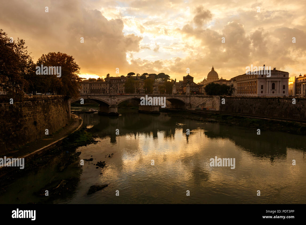 Una vista sul fiume Tevere con il Vittorio Emanuele II ponte e la Basilica di San Pietro alla fine. Roma, Italia. Foto Stock