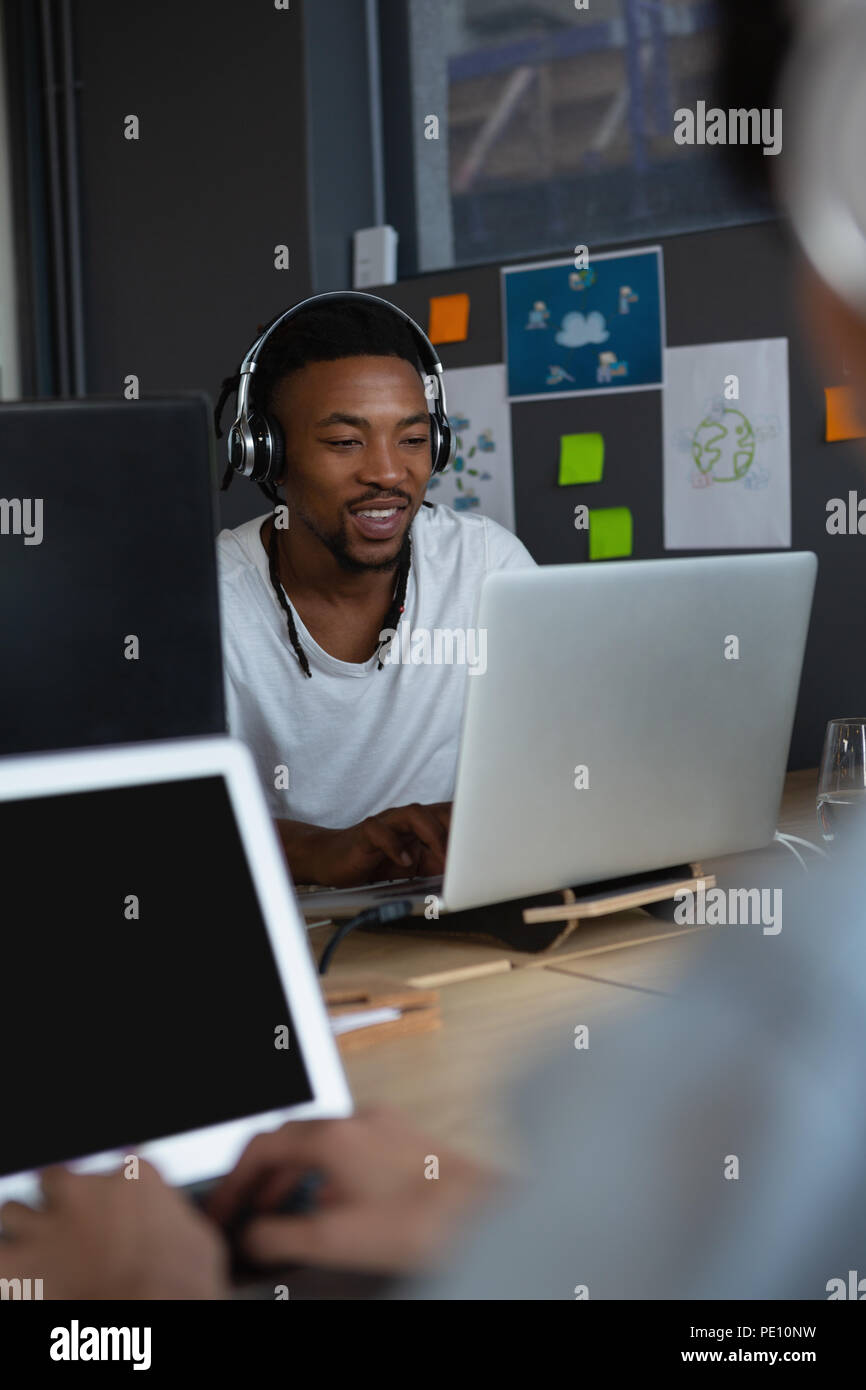 Dirigenti che lavorano su computer portatile alla scrivania in ufficio Foto Stock