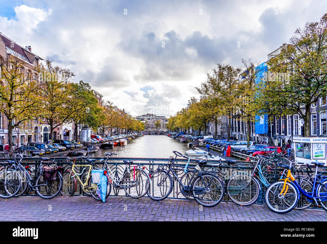 Bike incatenato alla ringhiera di un ponte sul Leidsestraat oltre il Keizersgracht è tipico per una bicicletta città come Amsterdam, Olanda Foto Stock