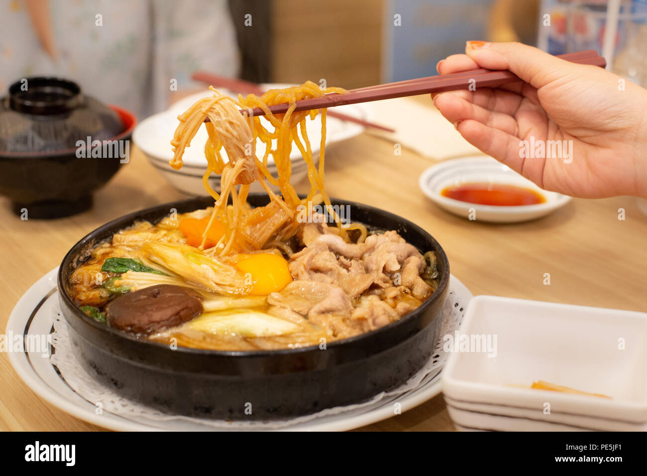 Ci sono due persone che mangiano carne di maiale shabu o hot pot. Tempo per la famiglia. Foto Stock