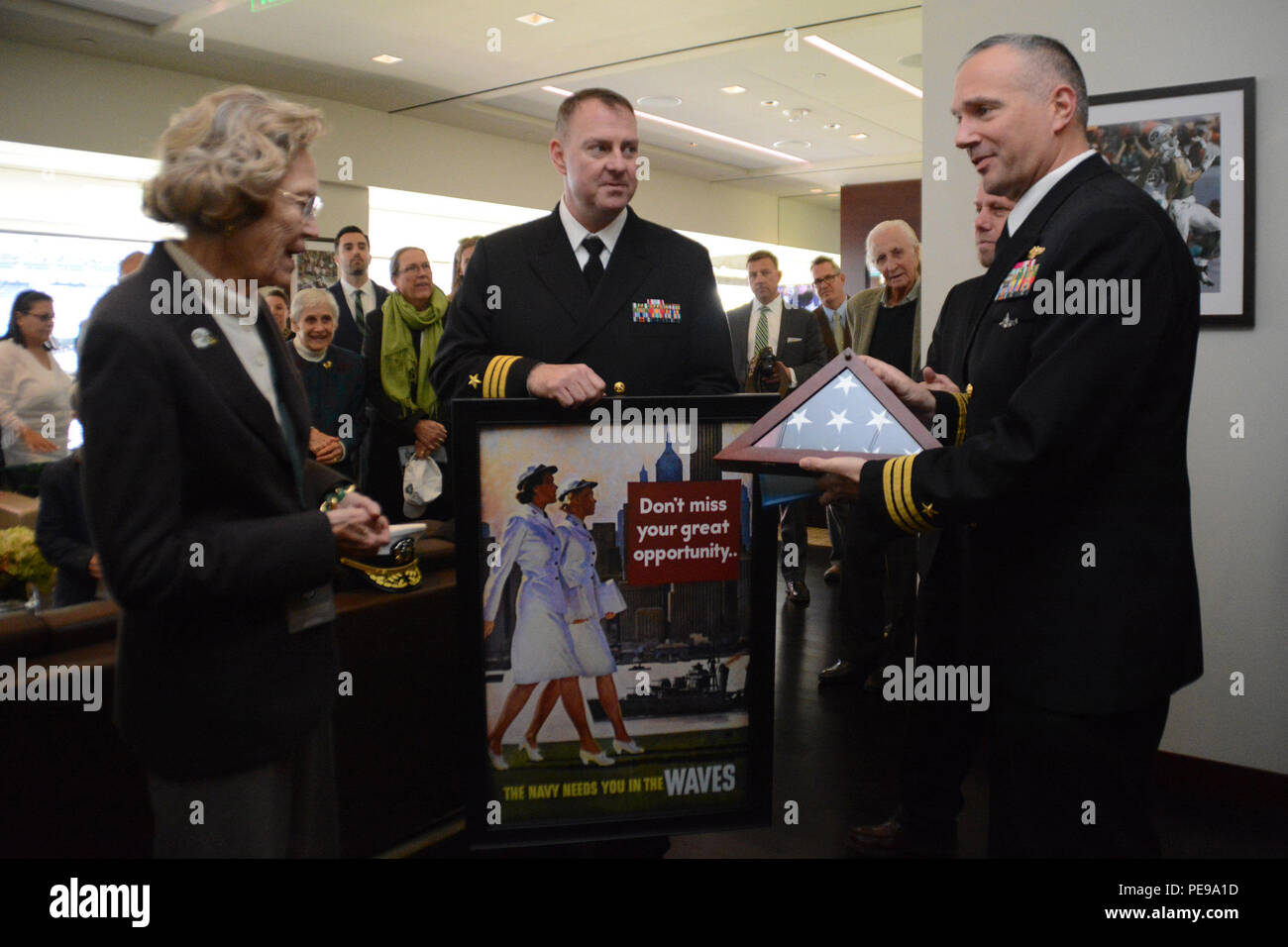 L'ufficiale comandante del sottomarino d'attacco classe Los Angeles USS Providence (SSN 719) presenta un distintivo nazionale in onore di un ex membro DELLE WAVES durante una partita di apprezzamento militare del Veterans Day al MetLife Stadium, East Rutherford, New Jersey, l'8 novembre 2015. Marinai e personale militare hanno partecipato a cerimonie che riconoscono il servizio, onorano i veterani e si sono impegnati con il pubblico durante un evento della National Football League con i New York Jets e i Jacksonville Jaguars. Foto Stock