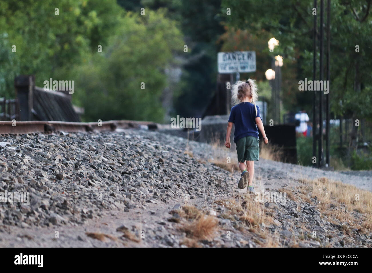 Un giovane bambino camminare da solo Foto Stock