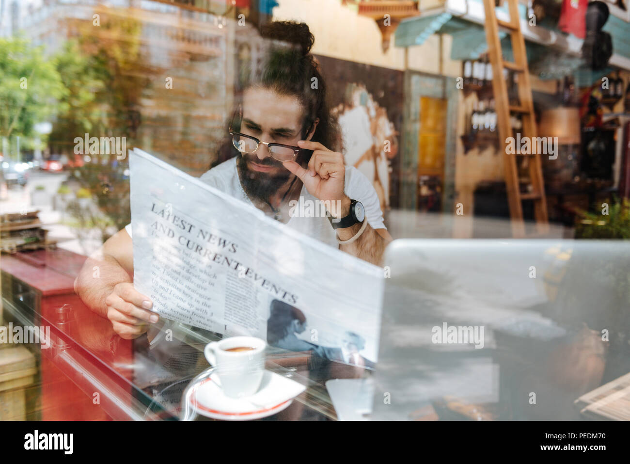 Nizza uomo intelligente che fissa i suoi occhiali Foto Stock