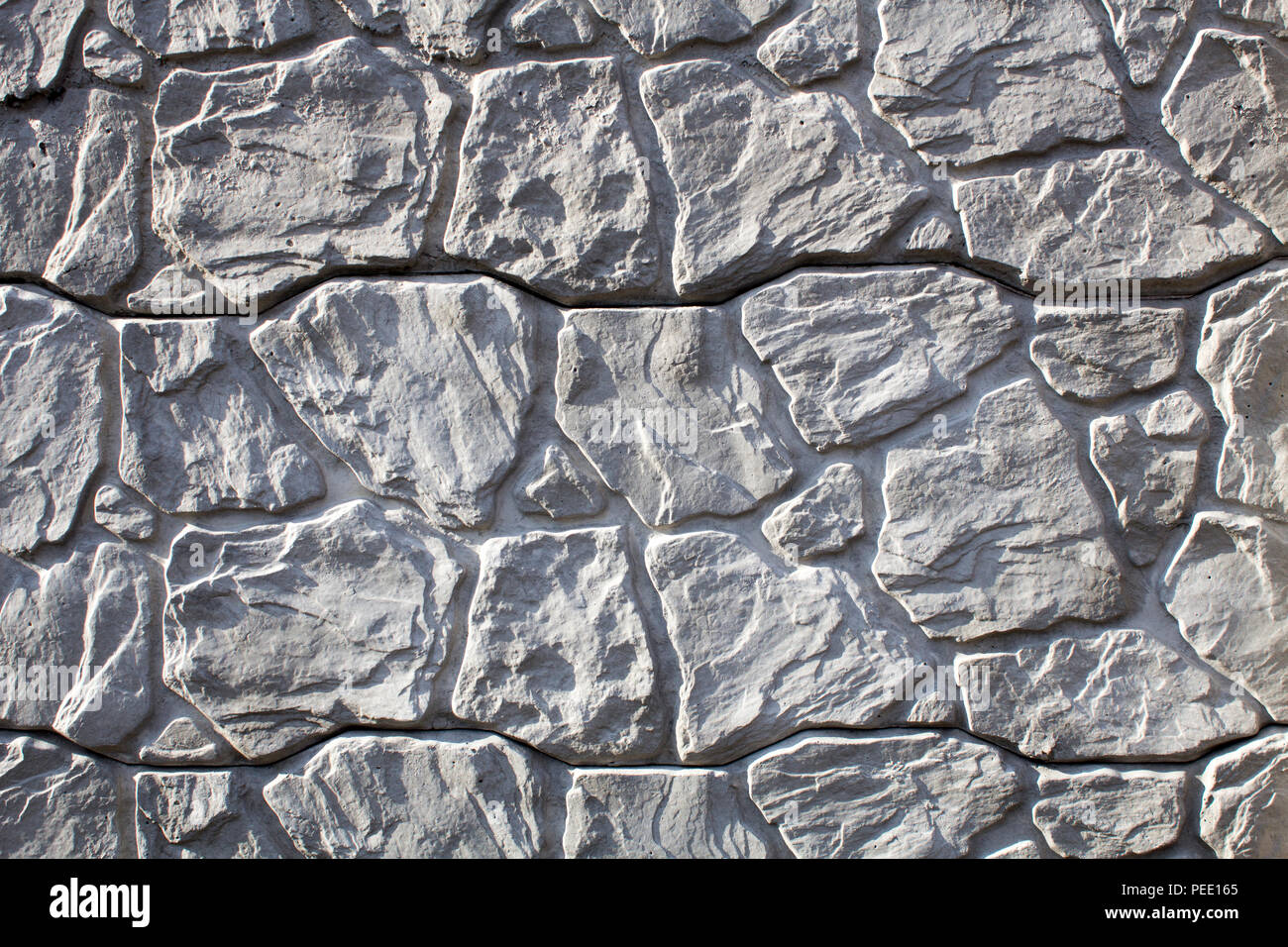 Recinzione di pietra ornamentale, ray sfondo stilizzato in una naturale e selvaggio stone Foto Stock