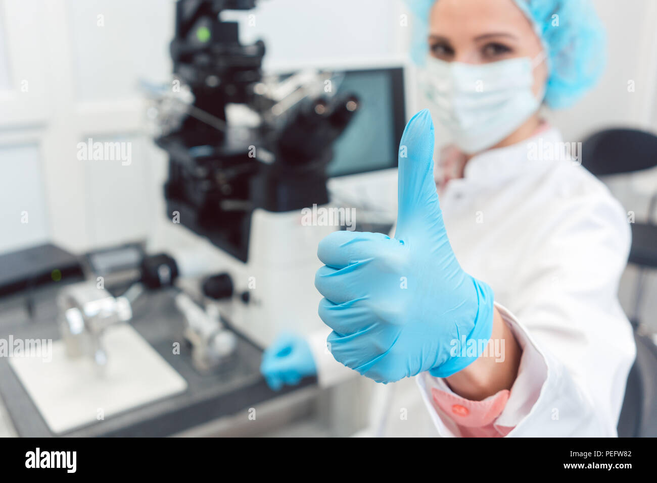 Dottore in laboratorio di fertilità avendo appena fertilizzato un uovo umano Foto Stock