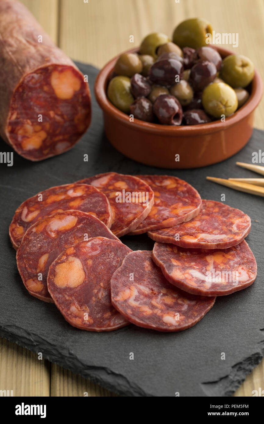 Pezzo tradizionale di spagnolo il salame chorizo e fette close up Foto Stock
