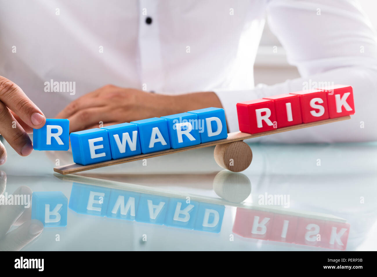 Imprenditore il lato che mostra uno squilibrio tra il premio di rischio e su altalena in legno Foto Stock