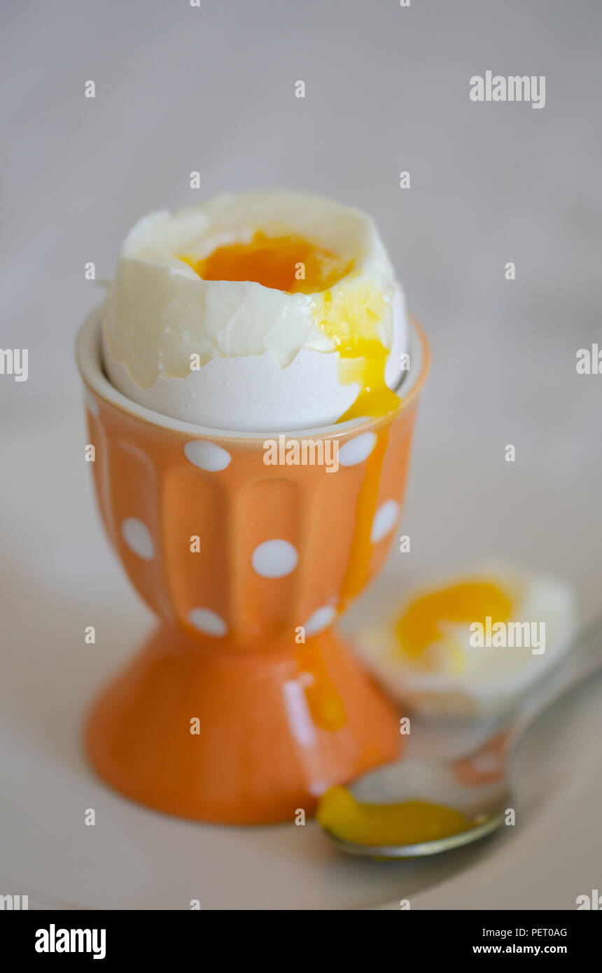 Uovo sodo per colazione in un arancio eggcup. Foto Stock