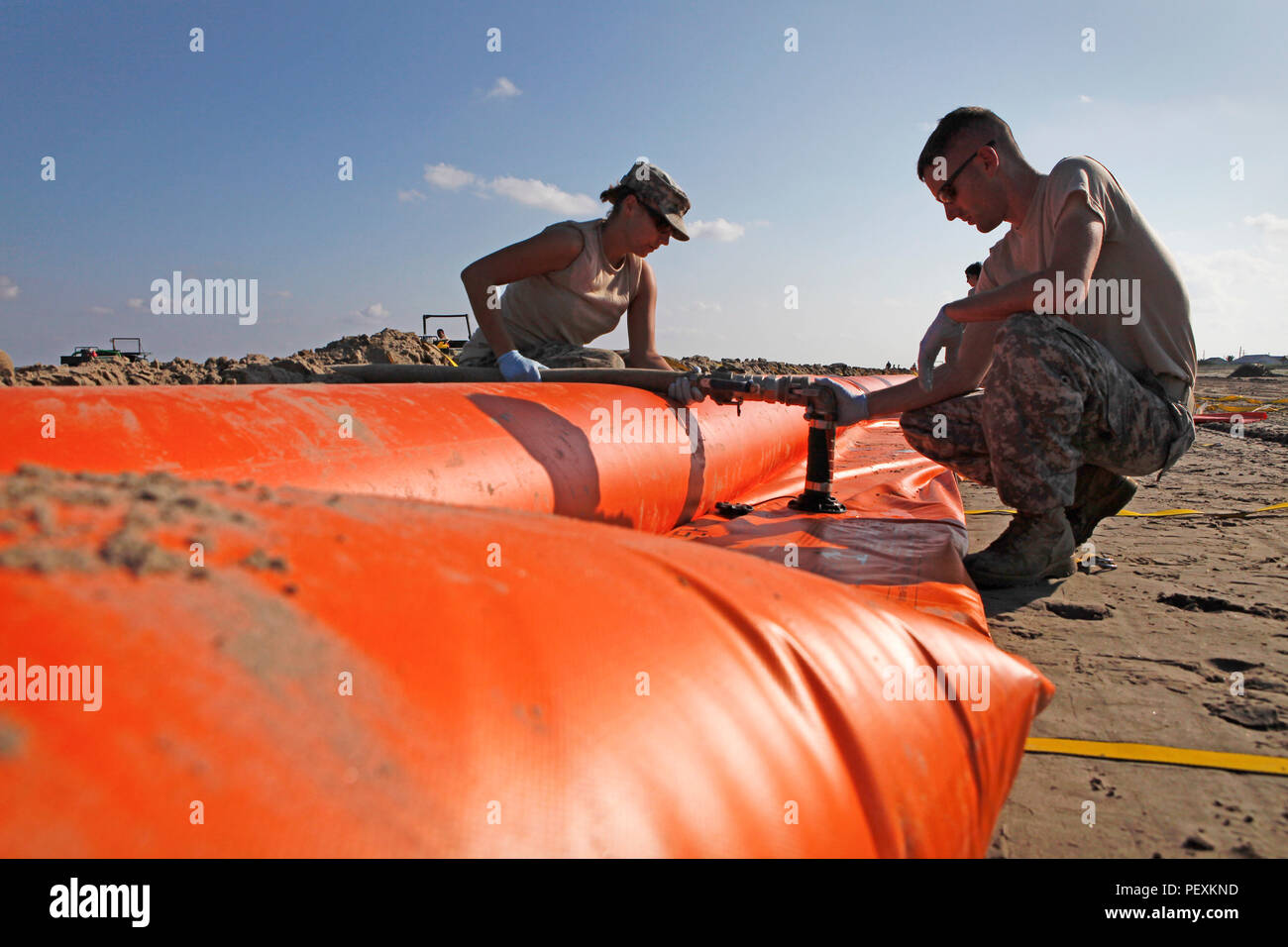 Membri della Louisiana National Guard per impostazione di barriere di contenimento per proteggere le spiagge di Grand Isle, Louisiana durante il 2010 Deepwater Horizon fuoriuscite di olio Foto Stock