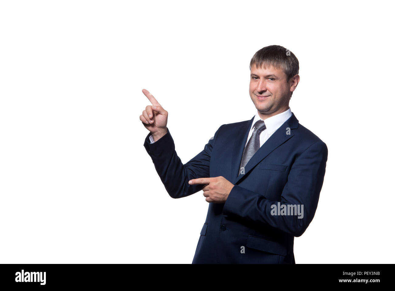 Bel giovane imprenditore con sorriso raggiante puntando con il dito Foto Stock