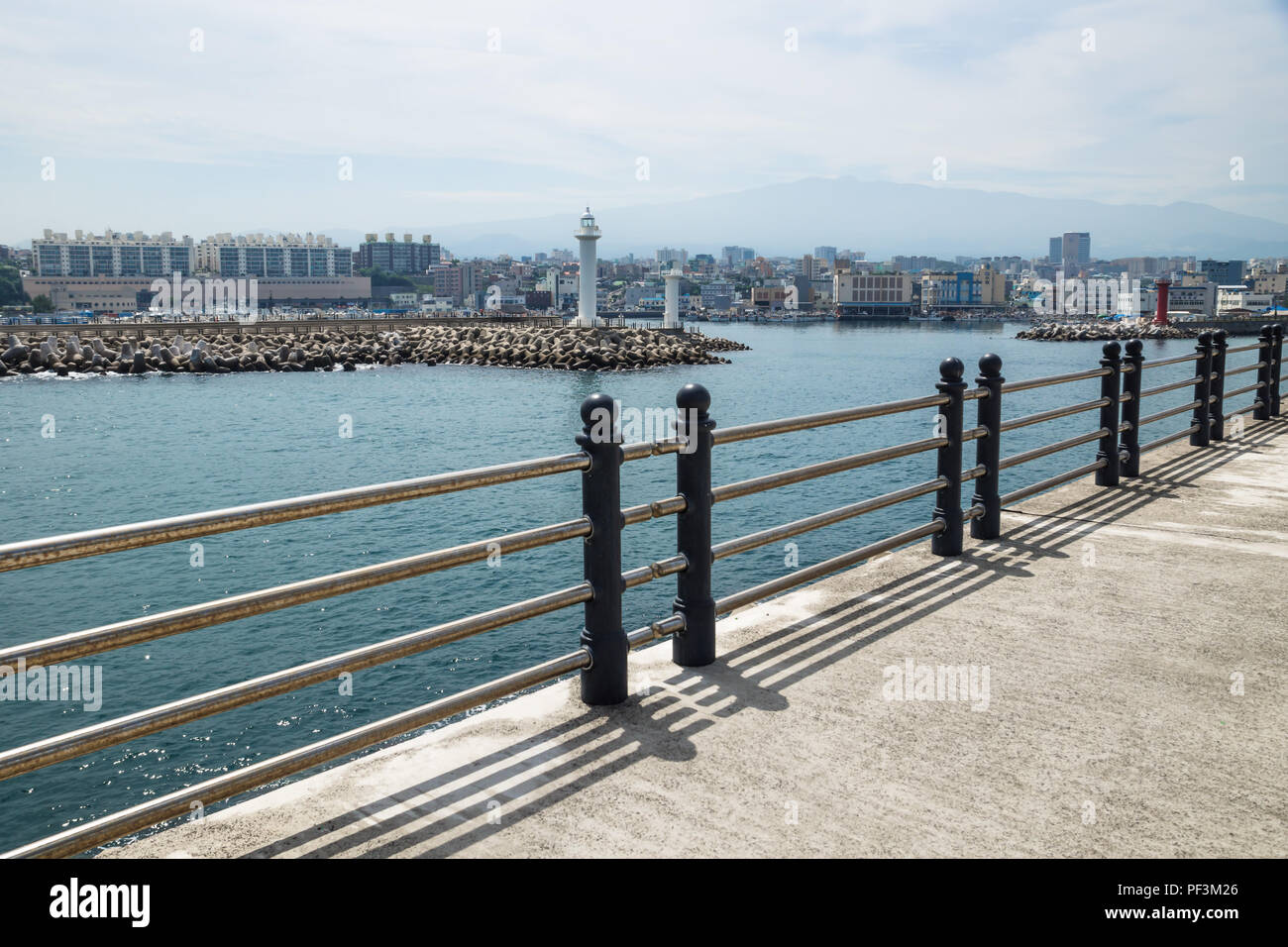 Jeju-si città principale vista oceano con faro e recinzione, Jeju-si, Jeju Island, Corea del Sud Foto Stock