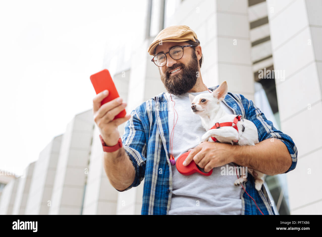 Moderno freelancer indossando rosso Orologio intelligente messaggio di digitazione Foto Stock