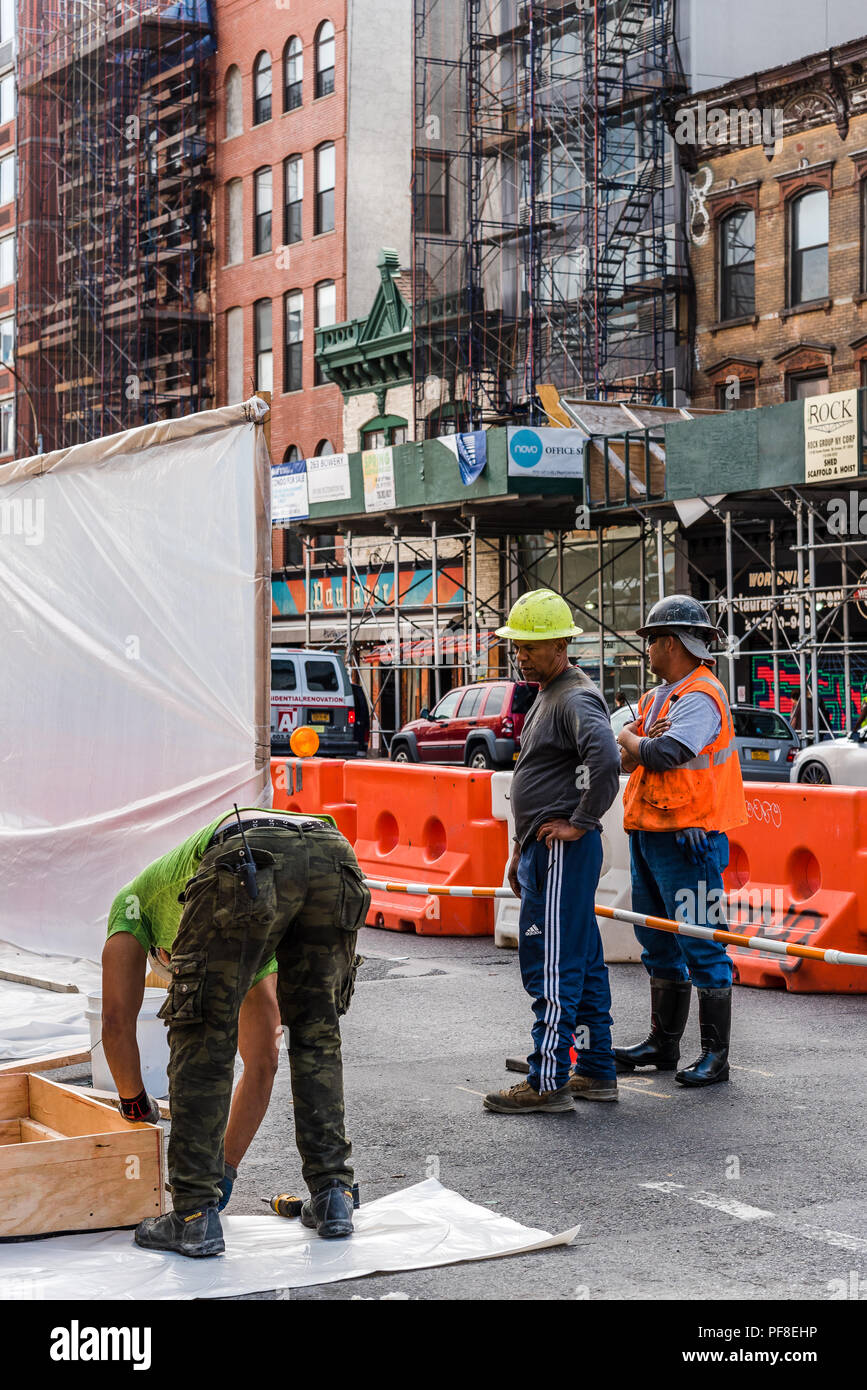La città di New York, Stati Uniti d'America - 20 Giugno 2018: Tre operai a lavorare sul sito in costruzione in Street a New York City Foto Stock