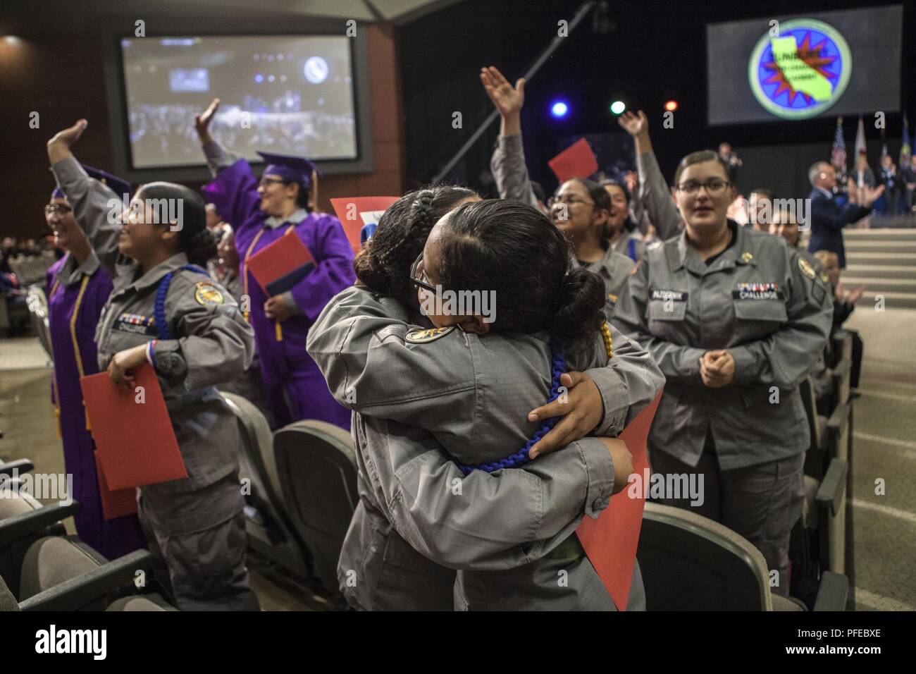 Cadetti femminile allietare e abbracciare durante il Sunburst sfida della gioventù Academy Classe 21 inizio cerimonia, Giugno 9, 2018 a Los Alamitos, California. Più di 150 cadetti in accademia della ventunesima classe camminava sul palco a ricevere i certificati di completamento per il mese 5.5 fase residenziale del 17,5 mese Guardia Nazionale programma sfida. Fase residenziale laureati ora entrare in un yearlong fase di mentorship per terminare il programma. Foto Stock