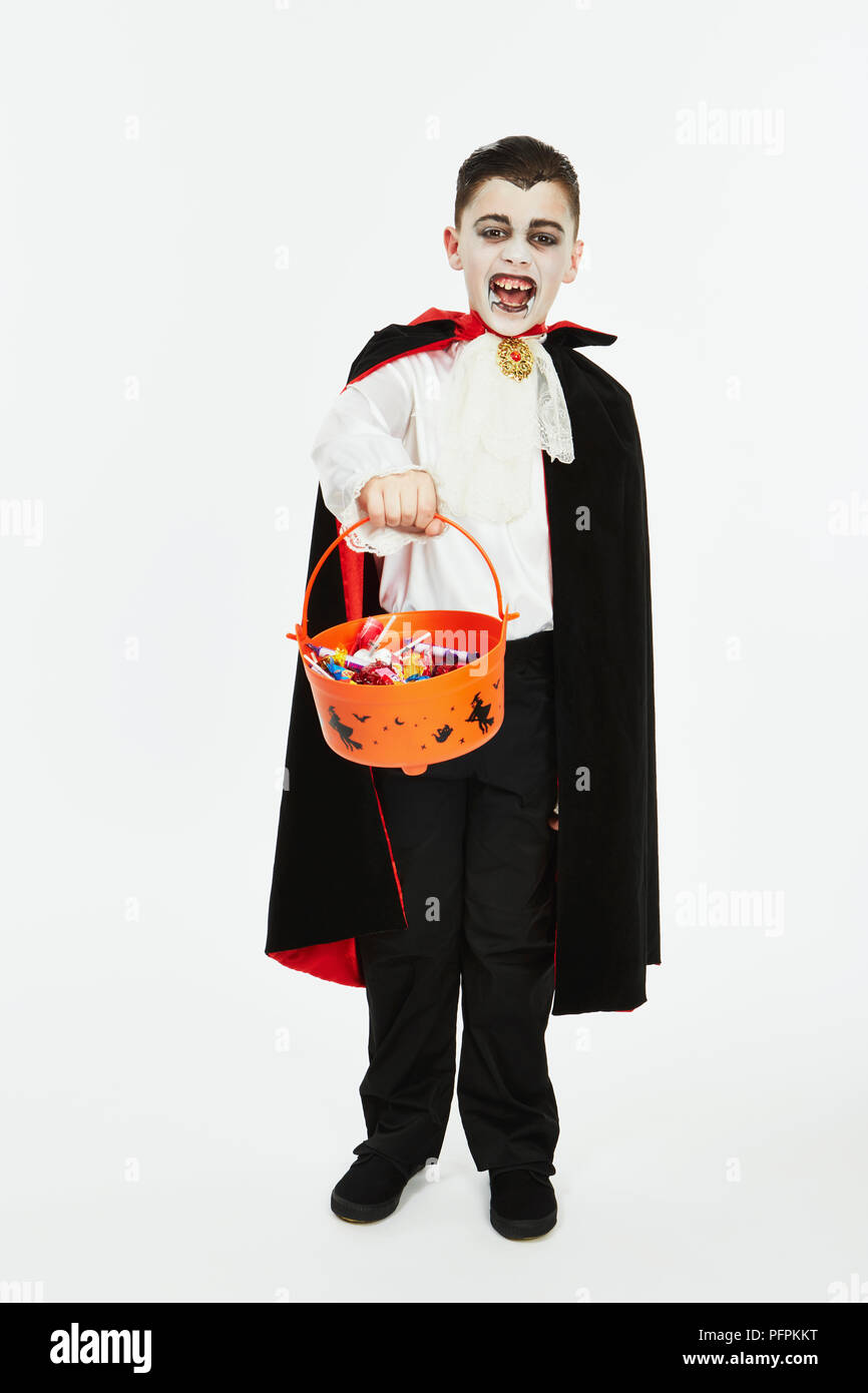 Bambino vestito come un vampiro per Halloween con un trucco-o-trattare la  benna Foto stock - Alamy