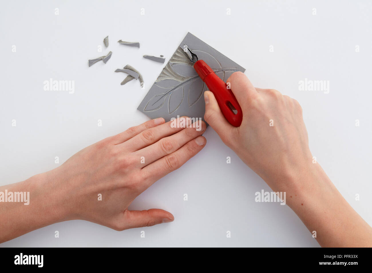 Utilizzando un lino taglierina per il taglio in forma di foglia (lino taglio, lino stampa) Foto Stock