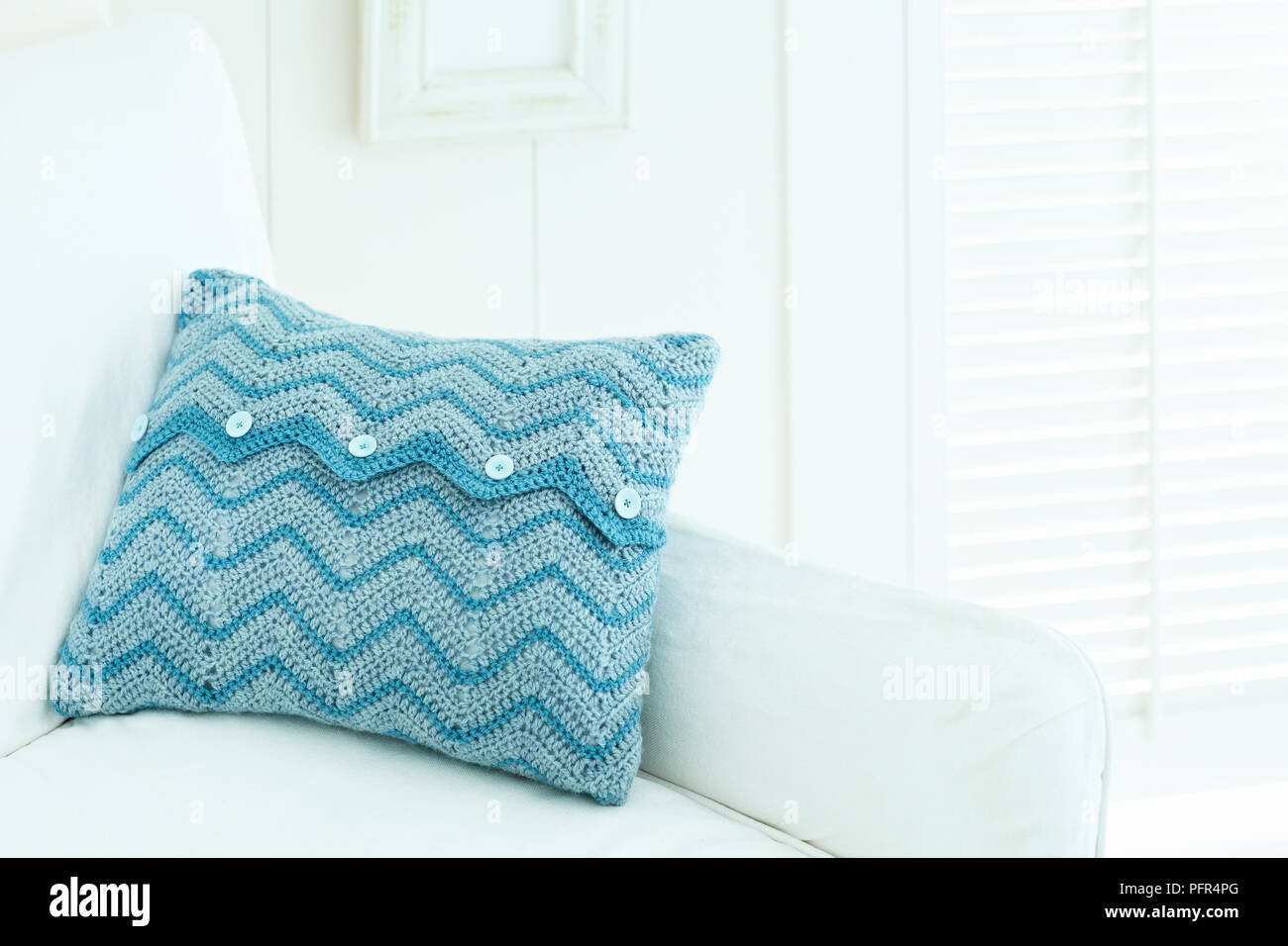Maglia blu cuscino sul divano Foto Stock