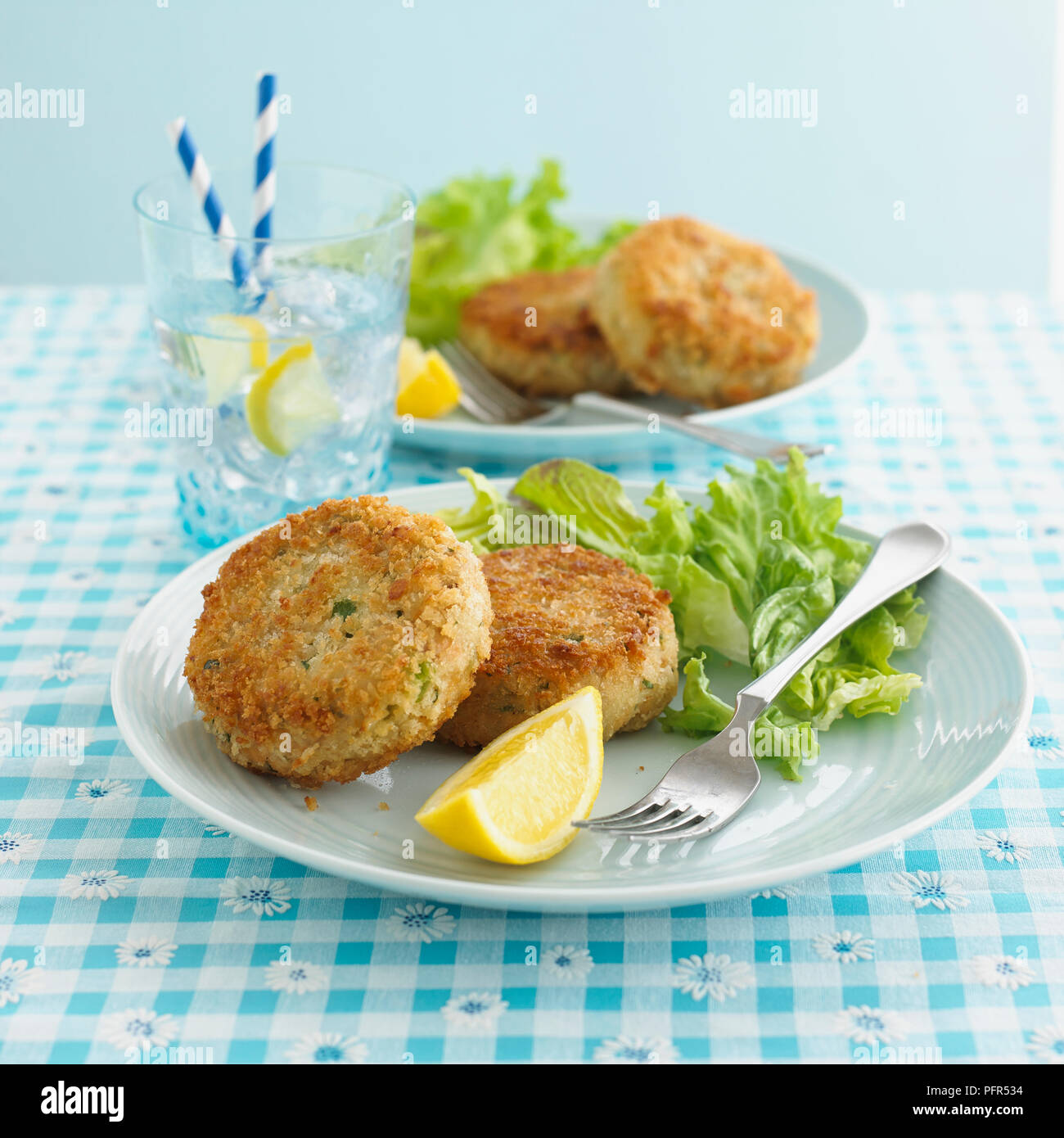 Piastra di due fishcakes ed insalata Foto Stock