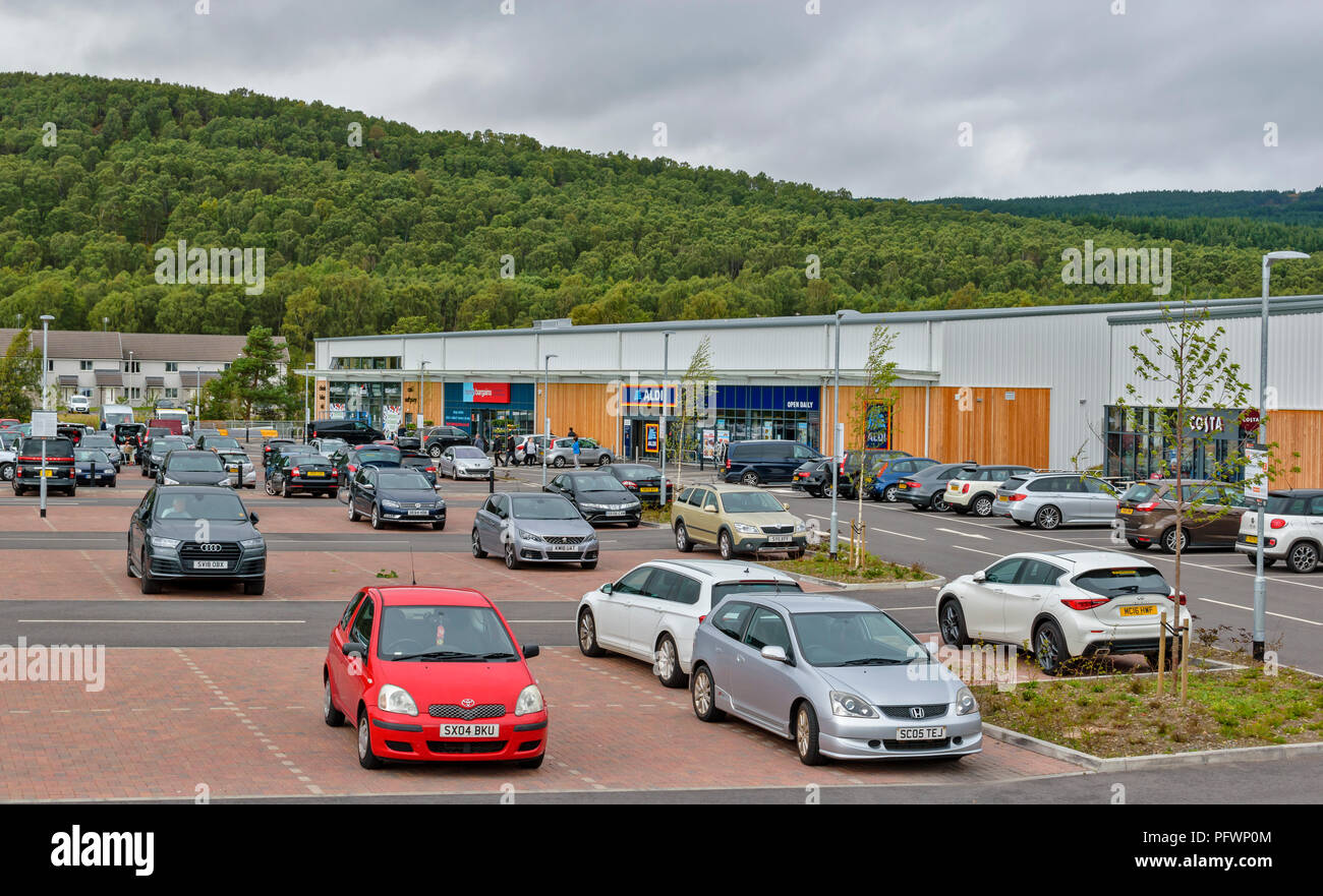 AVIEMORE Highlands della Scozia nuova area dello shopping grande parcheggio pieno di veicoli Foto Stock