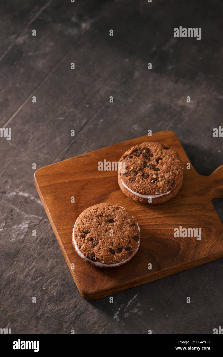 Cookie Ice Cream Sandwich isolati su tavola in legno rustico Foto Stock